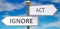 Ignore and act as different choices in life - pictured as words Ignore, act on road signs pointing at opposite ways to show that