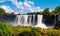 Iguazu waterfalls in Argentina. Panoramic view of several powerful water cascades creating mist over Iguazu river going through