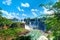 Iguazu waterfalls in Argentina, view from Devil`s Mouth, close-up on powerful water streams creating mist over Iguazu river. Sub-