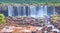 Iguazu waterfalls in Argentina, view from Devil`s Mouth, close-up on powerful water streams creating mist over Iguazu river. Sub-