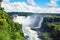 Iguazu waterfalls in Argentina, view from Devil`s Mouth. Panoramic view of many majestic powerful water cascades with mist and