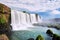 Iguazu waterfalls in Argentina, view from Devil`s Mouth. Panoramic view of many majestic powerful water cascades with mist.