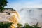 Iguazu waterfalls illuminated in yellow-gold by the low sun