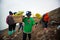 IJEN, INDONESIA - 11.11.2017: Sulfur miner carrying sulfur-laden baskets at Kawah Ijen volcano in Java, Indonesia.