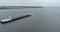 Ijselmeer, 3th of December 2022, The Netherlands. Inland shipping vessel on open water of Ijselmeer. Aerial drone follow