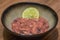 Ika Shiokara chopped marinated salty squid with a wedge of lime