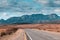 Ikara Flinders Ranges National Park. Panorama road heading to the mountains. No cars, no people in the picture. Dramatic cloudy