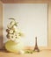 Ikebana and vintage photo-frame on table