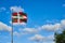 Ikurrina, Basque Country flag waving on a blue sky.