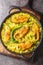 Ilish Polao or Hilsa Pulao is a Asian spicy Fish Pilaf closeup on the black pan on the table. Vertical top view