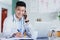 Ill pencil you in for tomorrow. a young male doctor making notes while working in a hospital.