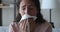 Ill sick young woman sneezing in tissue, blowing runny nose