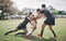 Ill take on the whole team. a focused young rugby player competing against his opponents during a match outside on a