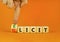 Illicit or elicit symbol. Businessman turns wooden cubes and changes the concept word Illicit to Elicit. Beautiful orange table