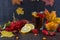 Illness concept: Cup of tea with autumn berries sea buckthorn, viburnum, rose hip, rowan and fall leaves. Drink with vitamin c