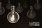 Illuminate your Ideas , Creativity innovation illuminated light bulb row dim ones concept solution