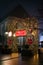 Illuminated archway lined with festive holiday lights at night