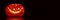Illuminated artistic Halloween pumpkin on black panoramic background Halloween web banner
