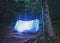 Illuminated blue tent at night forest , Carpathian