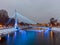 Illuminated bridge on winter river in Kharkiv city