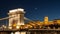 Illuminated Buda Castle and detailed view of Chain Bridge over Danube River in Budapest by night, Hungary