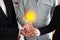 Illuminated bulb in businessman hands  liken their new idea