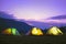 Illuminated camping tents in dark blue sky