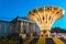 The illuminated carousel spins in the night. 2020 summer in the city folk festival in Munich