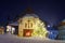 Illuminated Christmas fir tree in front of the church in Gruyere