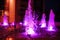 Illuminated colored night fountain in the city