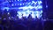 Illuminated concert hall with crowd of happy audience enjoying amazing music