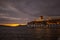 Illuminated cruise ship moored in the bay of Santorini at sunset