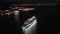 illuminated cruise ship in sea at night