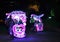 Illuminated decorated trishaw with soft toys at night in Malacca, Malaysia