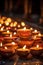 Illuminated Decorative Diya Candles in Darkness