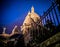 The illuminated domes of Sacre Coeur, Paris, against a deep blue night sky