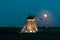 Illuminated dutch windmill and full moon near Rottemeren, Holland at night