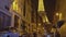 Illuminated Eiffel Tower at night, view from narrow street with high buildings