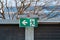 An illuminated emergency exit sign at a parking lot