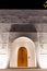 Illuminated entrance doors and facade of white Mosque of Light in Dubai.