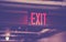 Illuminated exit sign, selective focus, color toning applied
