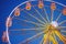 Illuminated ferris wheel in amusement park at a night city