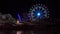 Illuminated ferris wheel in night sky