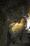 Illuminated by flashlight rock of Lapis Specularis in the Roman mine in The Sanabrio caves in Cuenca