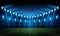 Illuminated Football Arena at night with blue spotlights, and starry night sky