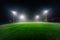 Illuminated football playground with green grass