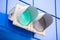 Illuminated green traffic signal light on classic blue wall of a garage