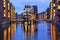 Illuminated house and two brides in Speicherstadt, Hamburg