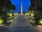 Illuminated lantern alley, running along memorial plates to a huge memorial of memory