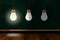 Illuminated Light Bulb With ChalkBoard Background And Copy Space